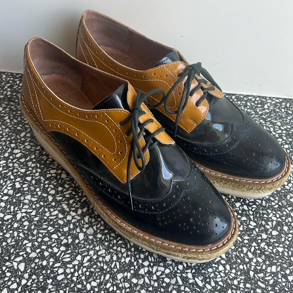Staccato Black and Tan Flats with Brogue Detailing